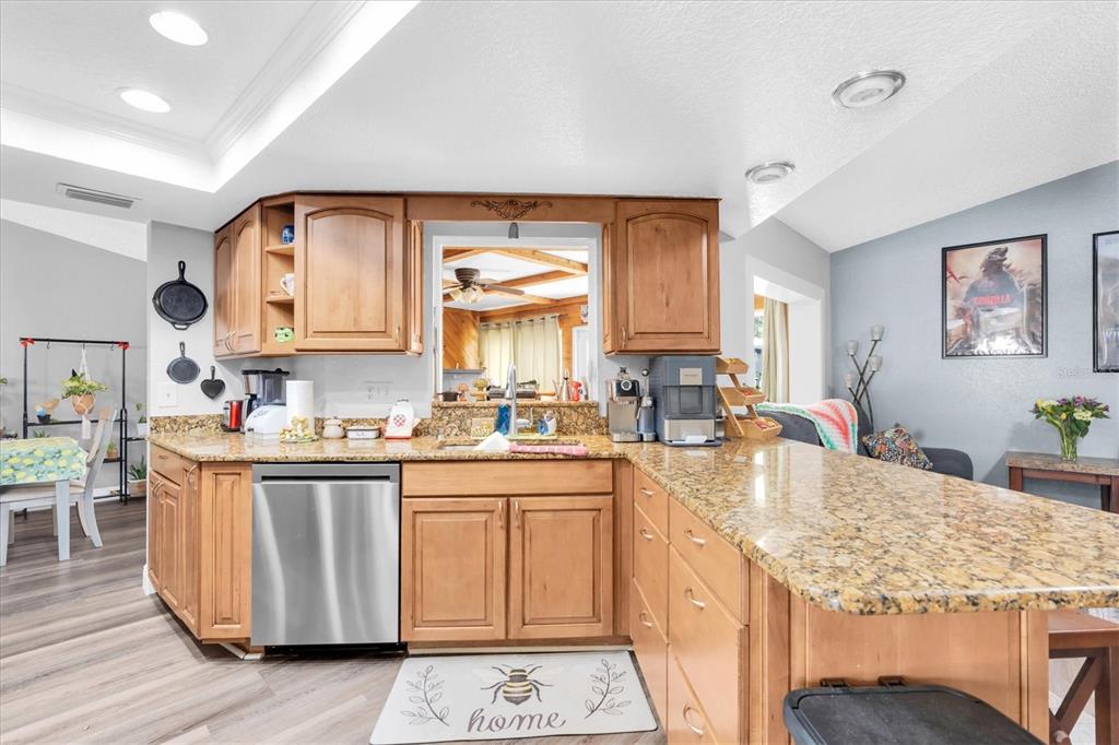 12107 72nd Way Largo, FL 33773 - Photo 12 of 40 a kitchen with granite countertop a sink stove and cabinets