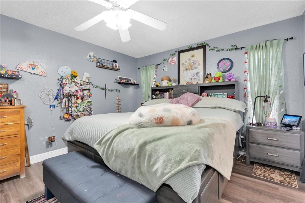 12107 72nd Way Largo, FL 33773 - Photo 20 of 40 a bedroom with bed and paintings on the wall