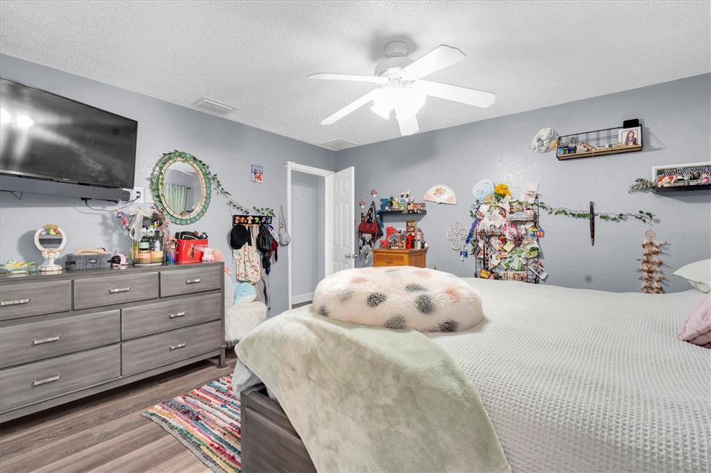 12107 72nd Way Largo, FL 33773 - Photo 21 of 40 a bedroom with a bed and a chandelier
