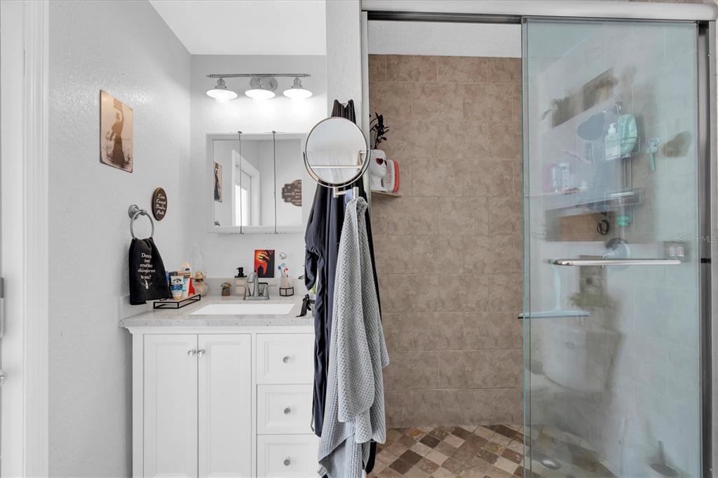 12107 72nd Way Largo, FL 33773 - Photo 23 of 40 a bathroom with a sink vanity and a mirror
