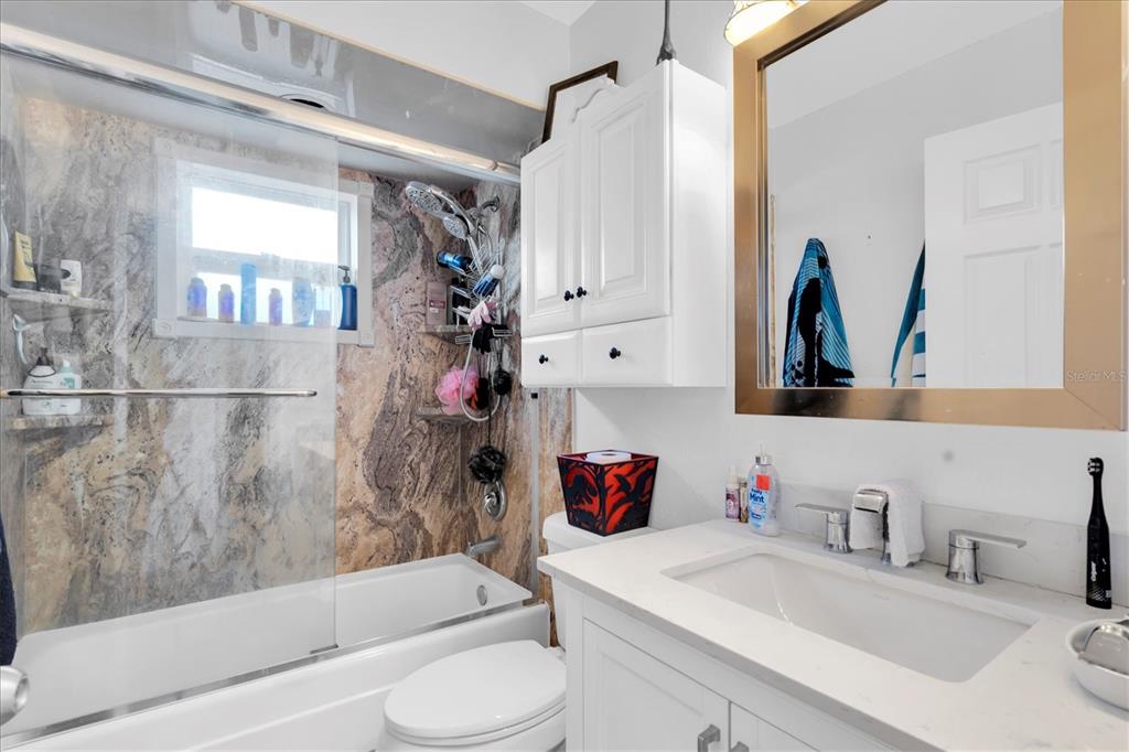 12107 72nd Way Largo, FL 33773 - Photo 28 of 40 a bathroom with a bathtub sink vanity mirror and toilet