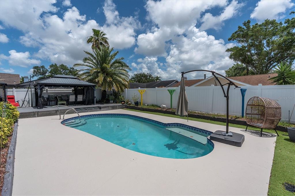 12107 72nd Way Largo, FL 33773 - Photo 30 of 40 a view of a swimming pool with a patio