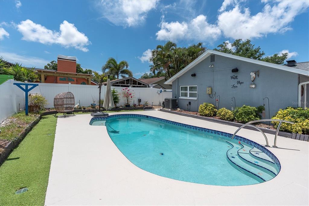 12107 72nd Way Largo, FL 33773 - Photo 3 of 40 a view of a swimming pool with a yard