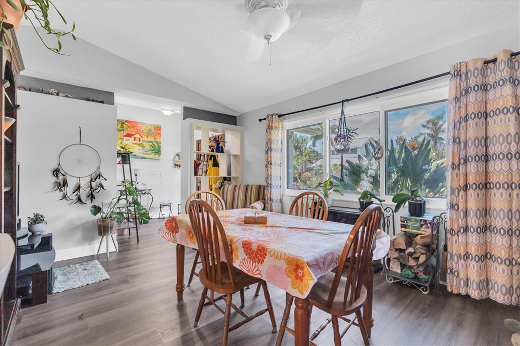 12107 72nd Way Largo, FL 33773 - Photo 6 of 40 a view of a dining room with furniture window and wooden floor