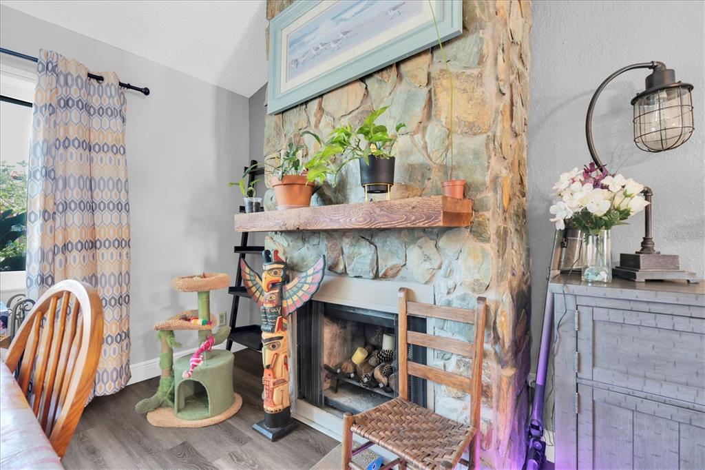12107 72nd Way Largo, FL 33773 - Photo 7 of 40 a dining room with fireplace furniture and a potted plant