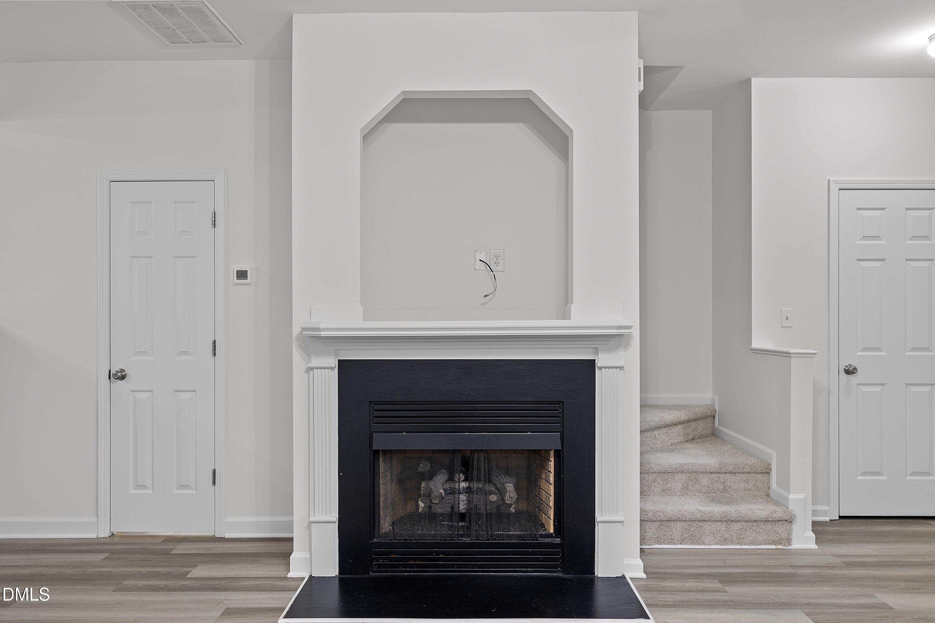 8321 Glenwood Springs Court Raleigh, NC 27616 - Photo 10 of 37 a living room with a fireplace