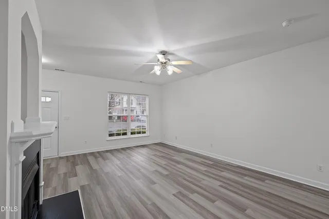 wooden floor in an empty room with a window