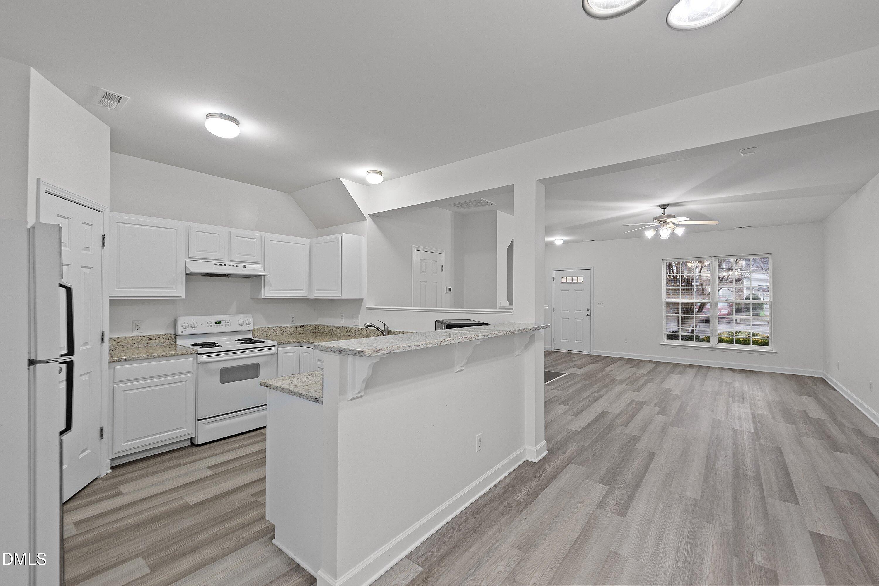 8321 Glenwood Springs Court Raleigh, NC 27616 - Photo 16 of 37 a kitchen with stainless steel appliances a stove top oven a sink dishwasher and a refrigerator