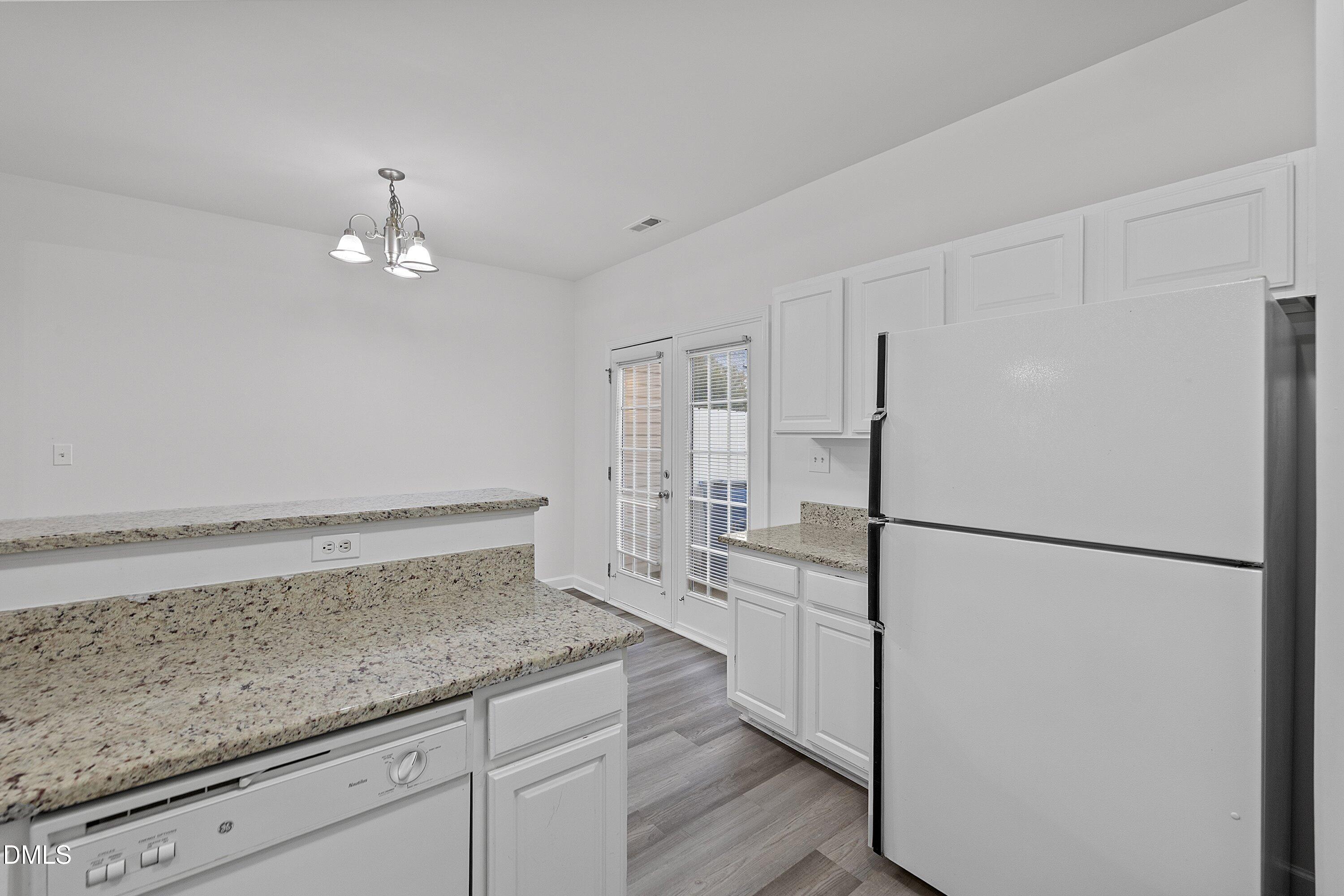 8321 Glenwood Springs Court Raleigh, NC 27616 - Photo 19 of 37 a kitchen with a refrigerator a sink and dishwasher