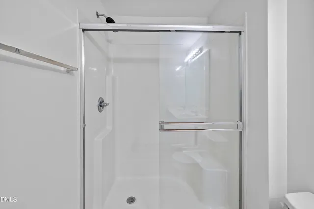 a bathroom with a glass shower door