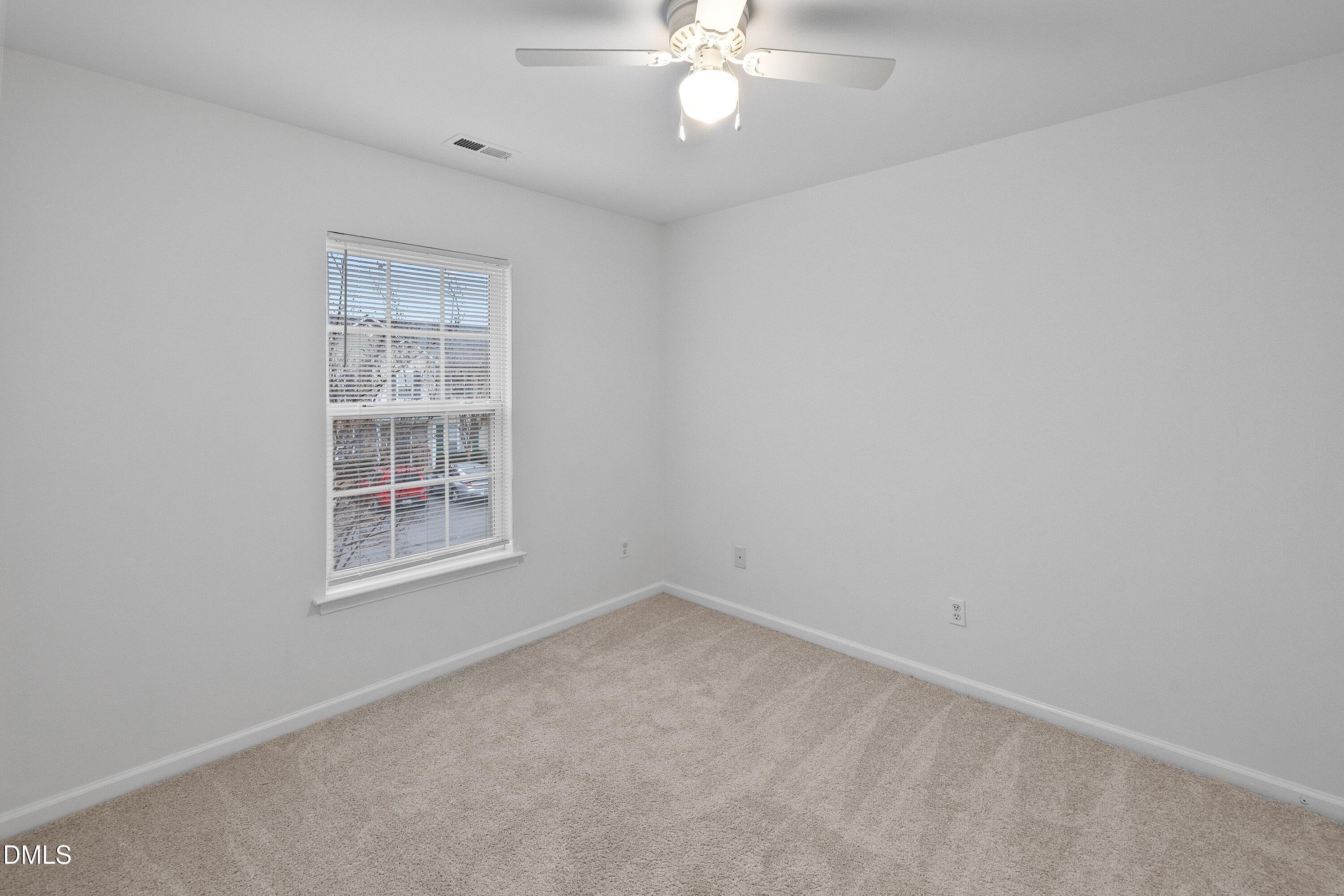 8321 Glenwood Springs Court Raleigh, NC 27616 - Photo 29 of 37 an empty room with windows and fan