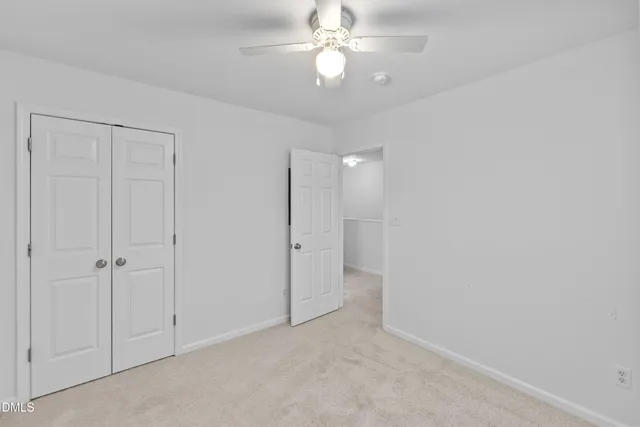 an empty room with a ceiling fan and a ceiling fan