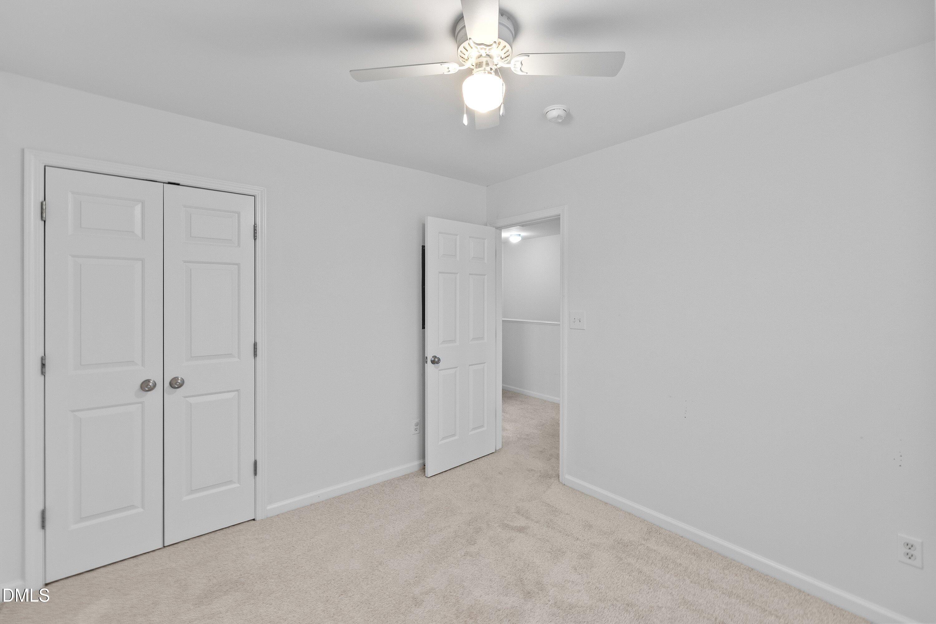 8321 Glenwood Springs Court Raleigh, NC 27616 - Photo 30 of 37 an empty room with a ceiling fan and a ceiling fan