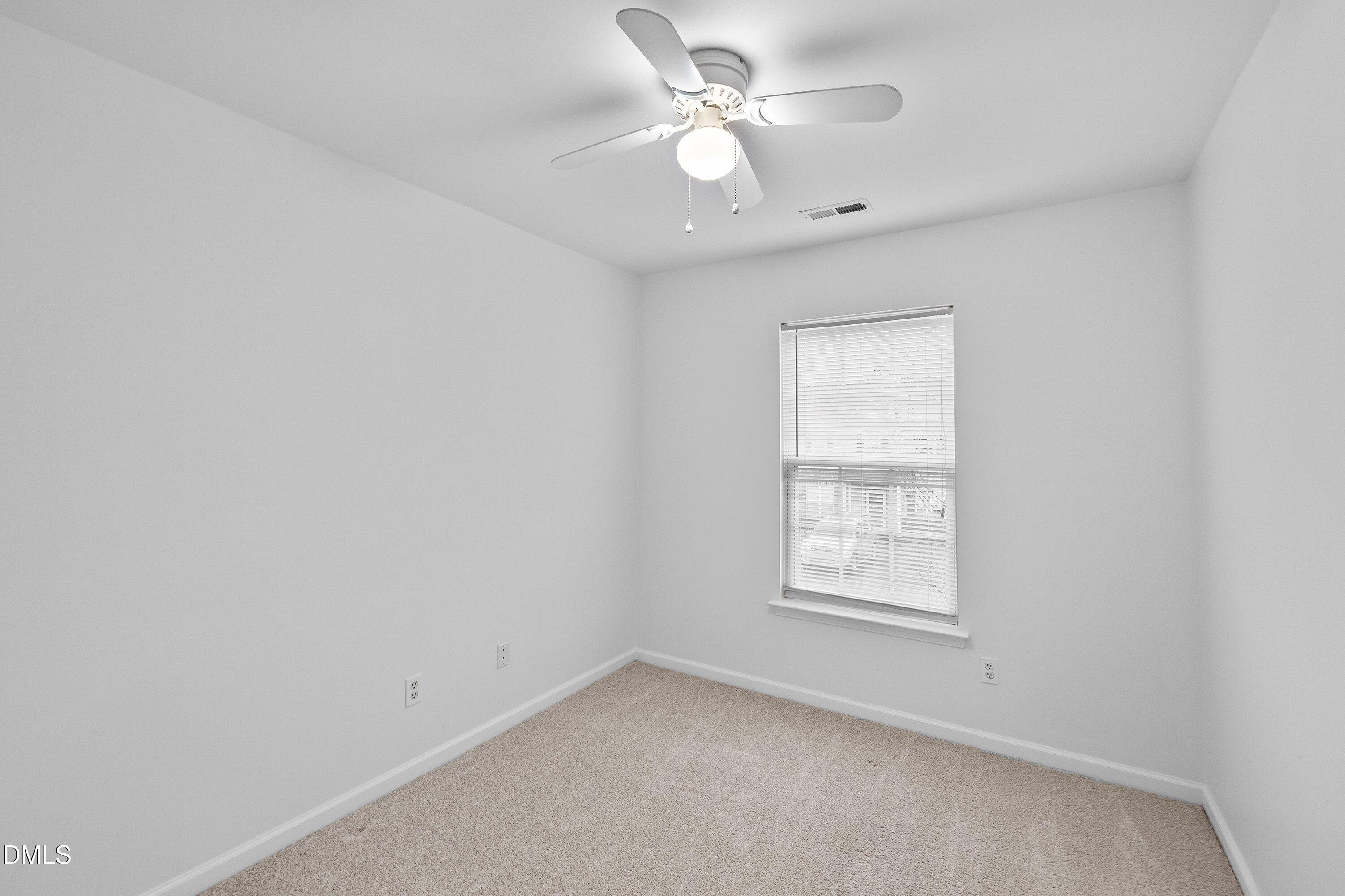 8321 Glenwood Springs Court Raleigh, NC 27616 - Photo 31 of 37 an empty room with windows and fan