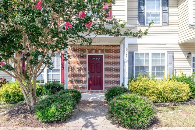 a front view of a house with plants