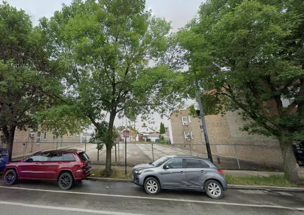 a view of cars parked on the side of a street