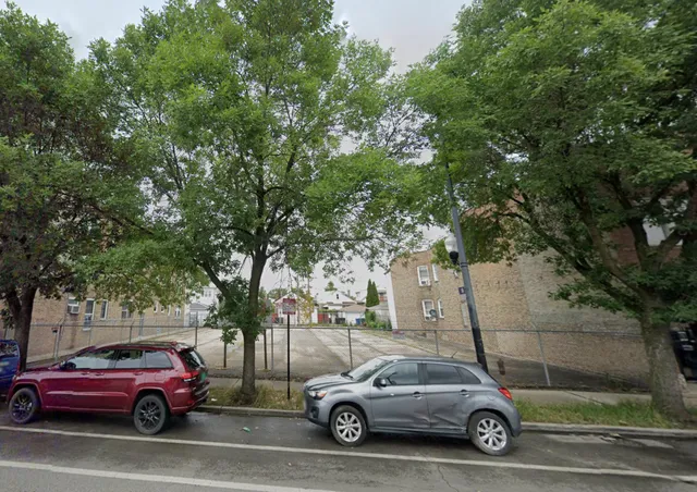 a view of cars parked on the side of a street