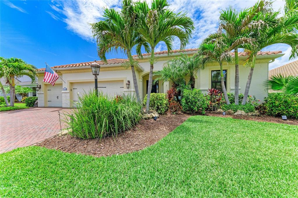 12642 Harney Street Venice, FL 34293 - Photo 4 of 85 a front view of a house with garden