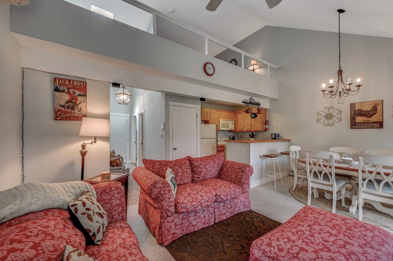 116 Snow Ridge Cir Lake Lake Harmony, PA 18624 - Photo 16 of 48 a living room with furniture a chandelier and kitchen view