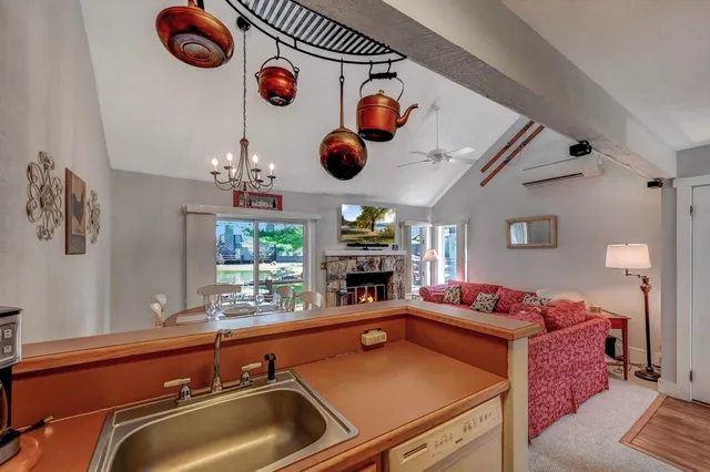 a bathroom with a granite countertop toilet sink and mirror