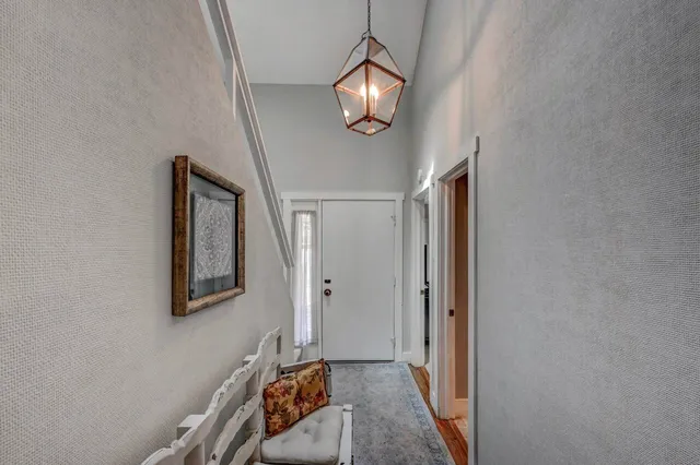 a bathroom with a granite countertop sink a toilet a large mirror and shower