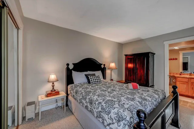a view of staircase with a rug and a chandelier