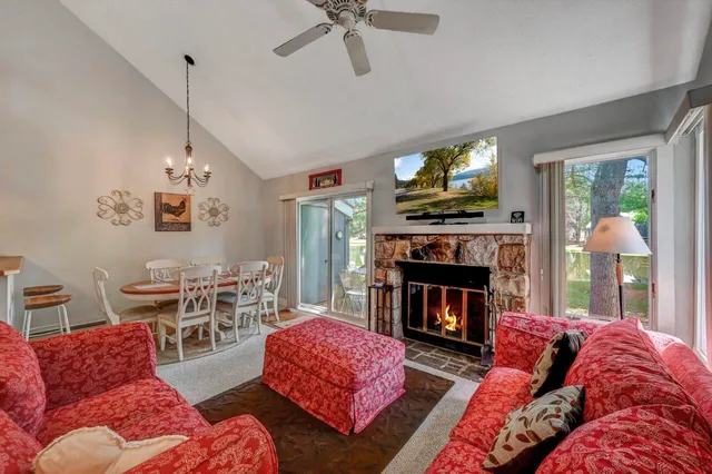 a living room with furniture a fireplace and a flat screen tv