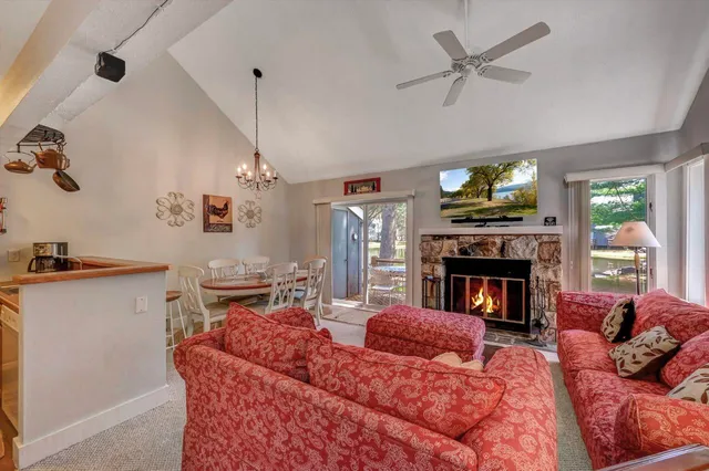 a living room with furniture fireplace and window
