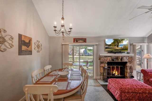 a living room with furniture a fireplace and a large window
