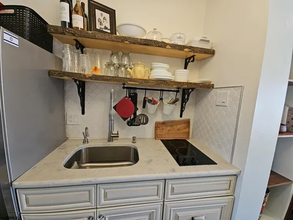 a kitchen with a refrigerator stove and cabinets