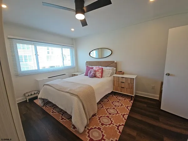 a bedroom with a bed and a mirror