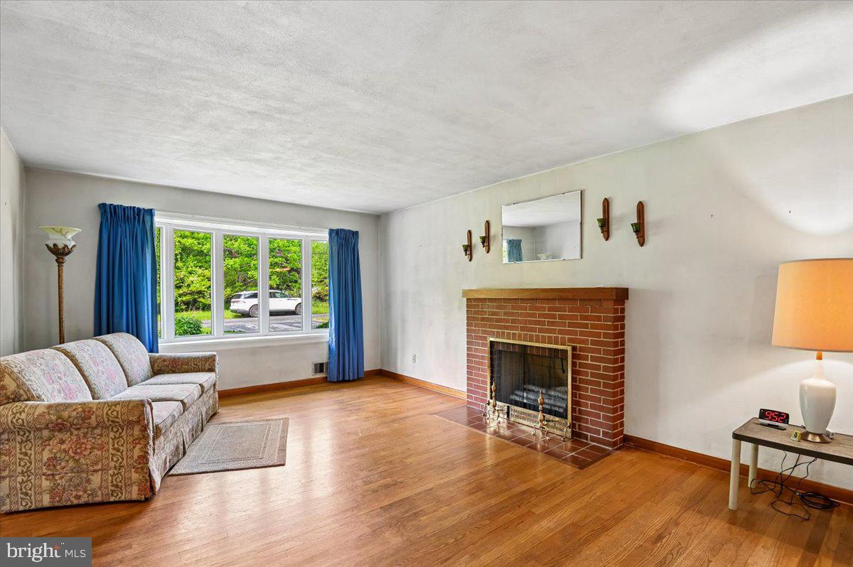 1509 Duvall Road Annapolis, MD 21409 - Photo 16 of 39 a living room with furniture and a fireplace