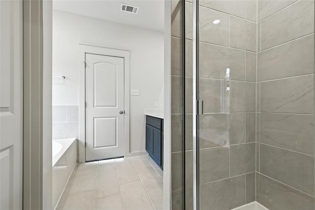 1795 Gleasondale Place Forney, TX 75126 - Photo 19 of 29 Bathroom with vanity, a garden tub, and a shower stall