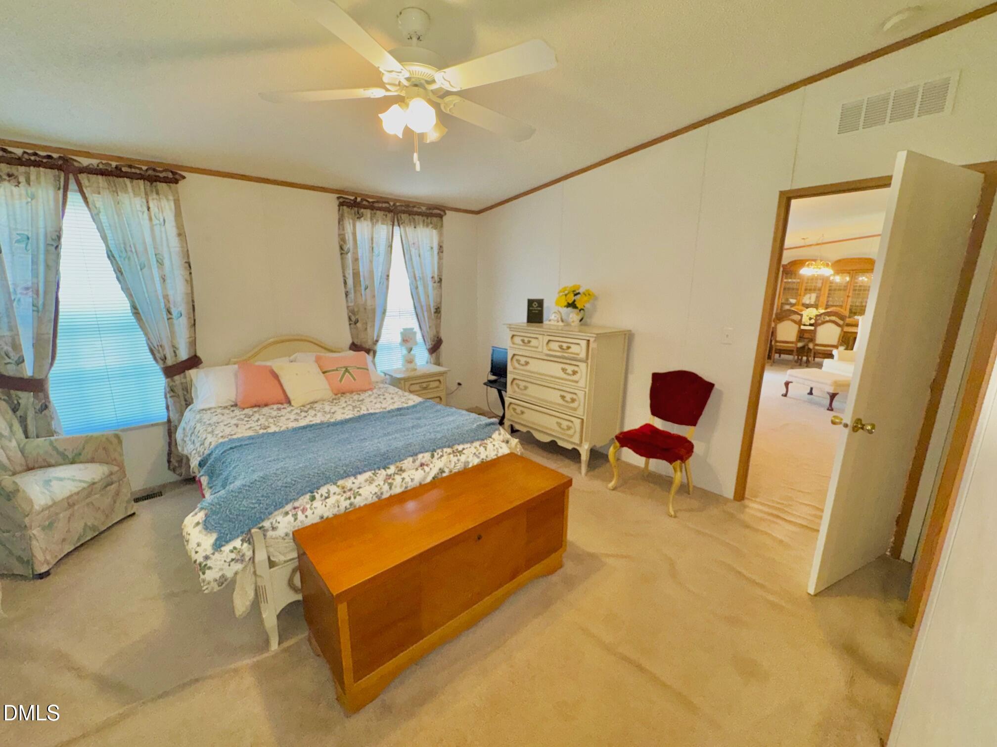 1595 Spring Valley Lake Road Henderson, NC 27537 - Photo 13 of 27 a bedroom with a bed dresser and a window