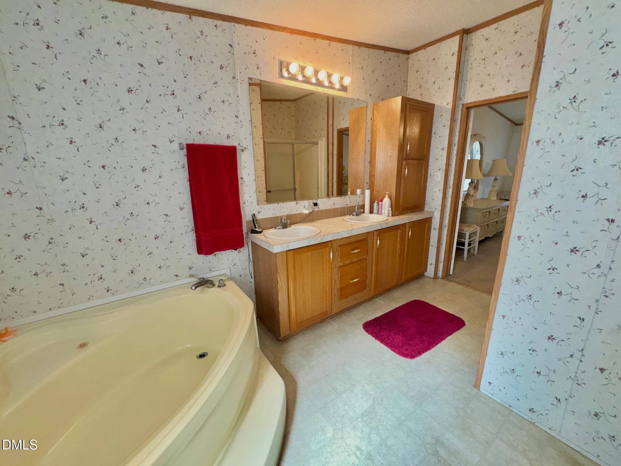 1595 Spring Valley Lake Road Henderson, NC 27537 - Photo 15 of 27 a bathroom with a tub sink and mirror