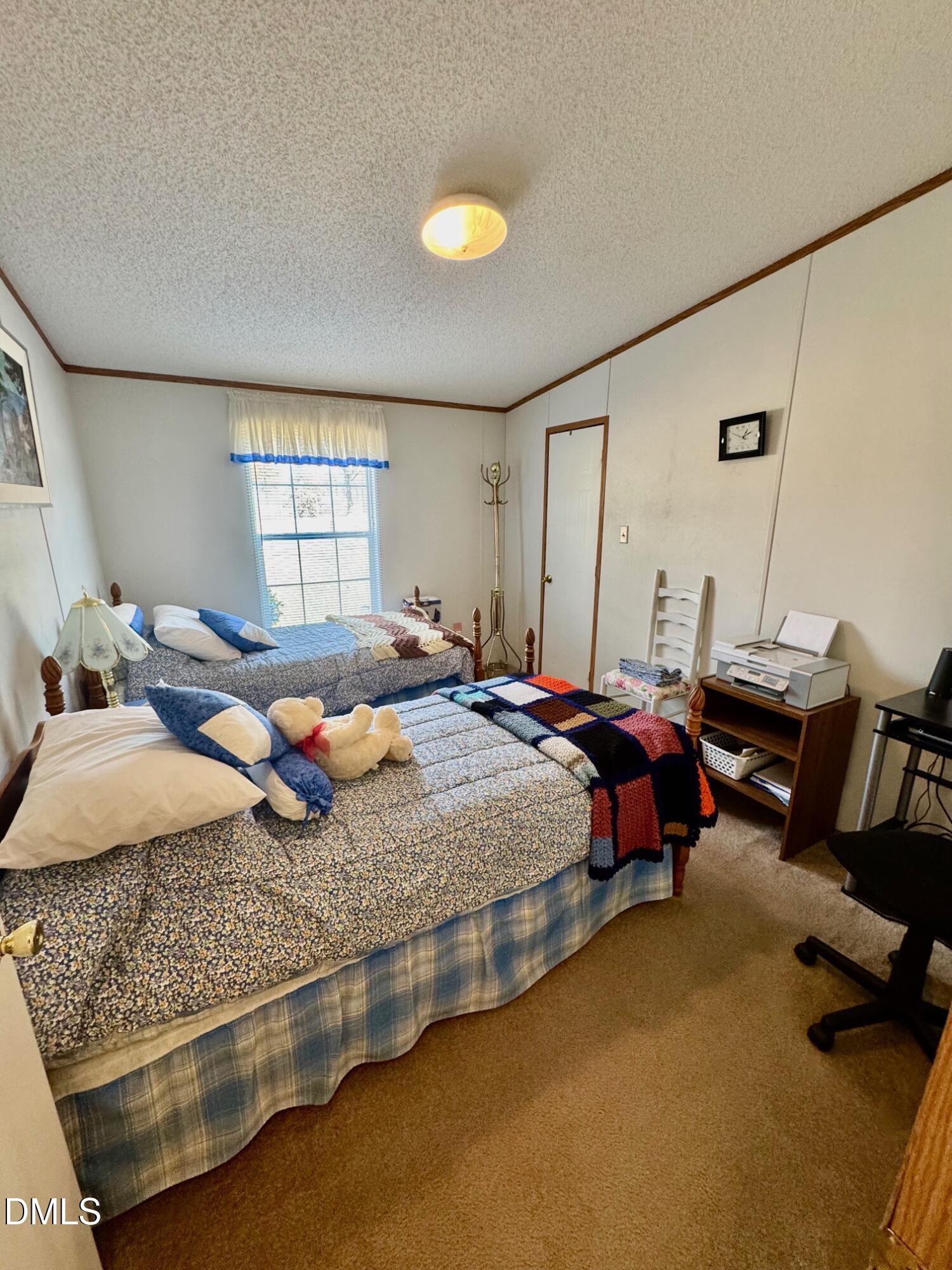 1595 Spring Valley Lake Road Henderson, NC 27537 - Photo 16 of 27 a bed room with a bed and a window