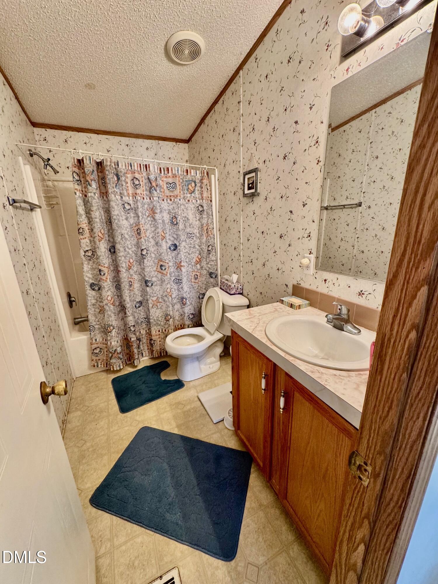 1595 Spring Valley Lake Road Henderson, NC 27537 - Photo 17 of 27 a bathroom with a sink and a mirror