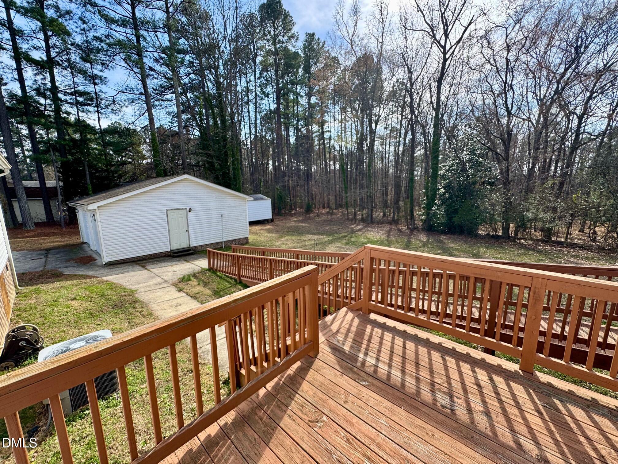 1595 Spring Valley Lake Road Henderson, NC 27537 - Photo 20 of 27 a view of a wooden deck and trees with wooden fence