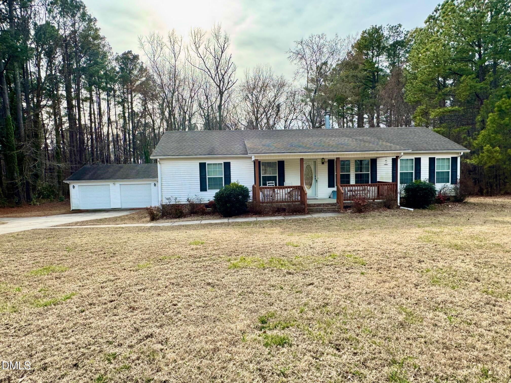1595 Spring Valley Lake Road Henderson, NC 27537 - Photo 2 of 27 a front view of a house with a yard and trees
