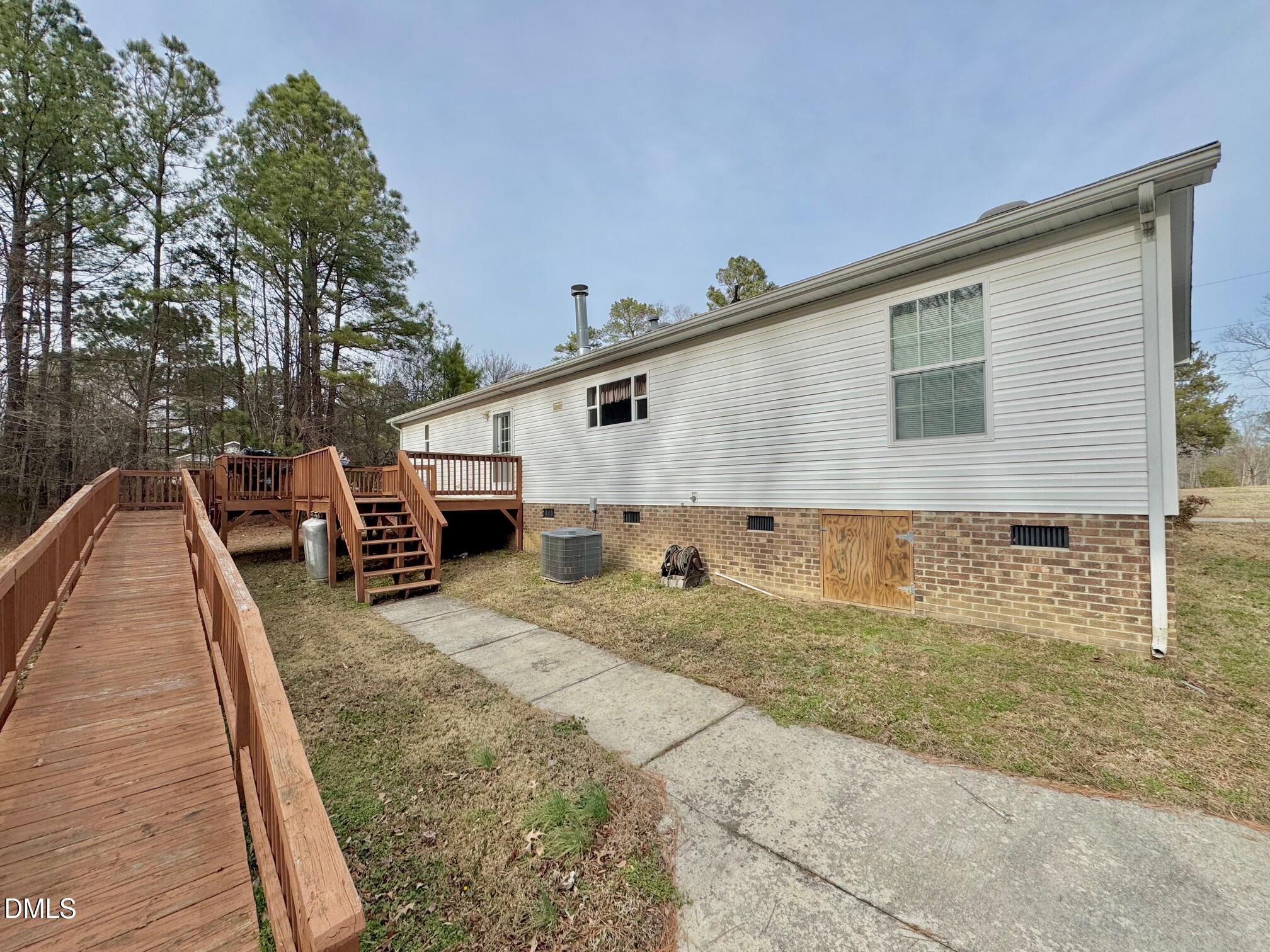 1595 Spring Valley Lake Road Henderson, NC 27537 - Photo 21 of 27 a view of a house with backyard