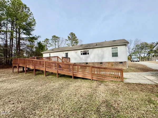 a view of a house with a wooden fence