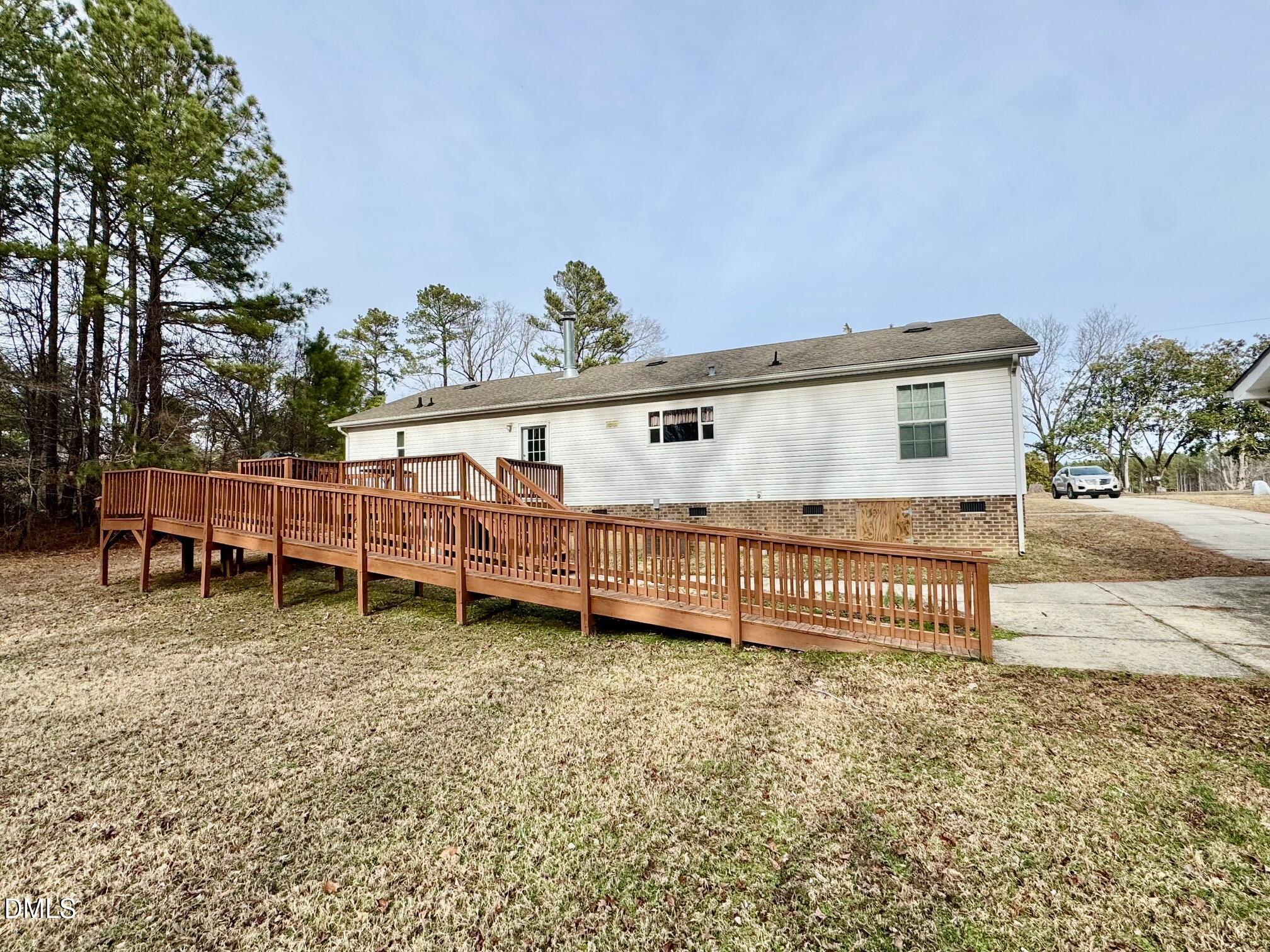 1595 Spring Valley Lake Road Henderson, NC 27537 - Photo 22 of 27 a view of a house with a wooden fence