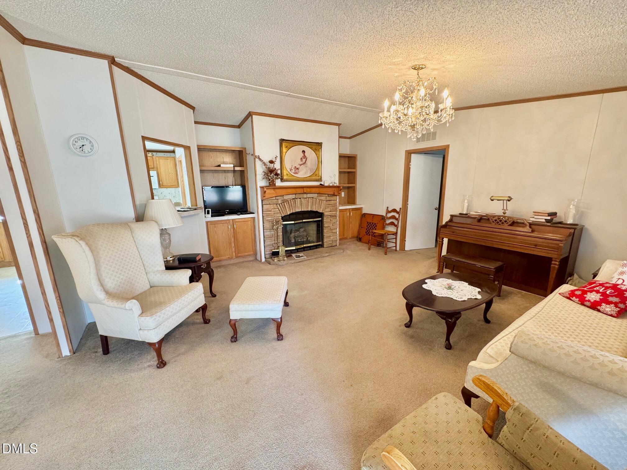 1595 Spring Valley Lake Road Henderson, NC 27537 - Photo 4 of 27 a living room with furniture and a fireplace