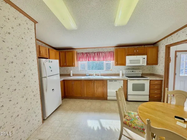 a kitchen with stainless steel appliances a stove a refrigerator and a cabinets