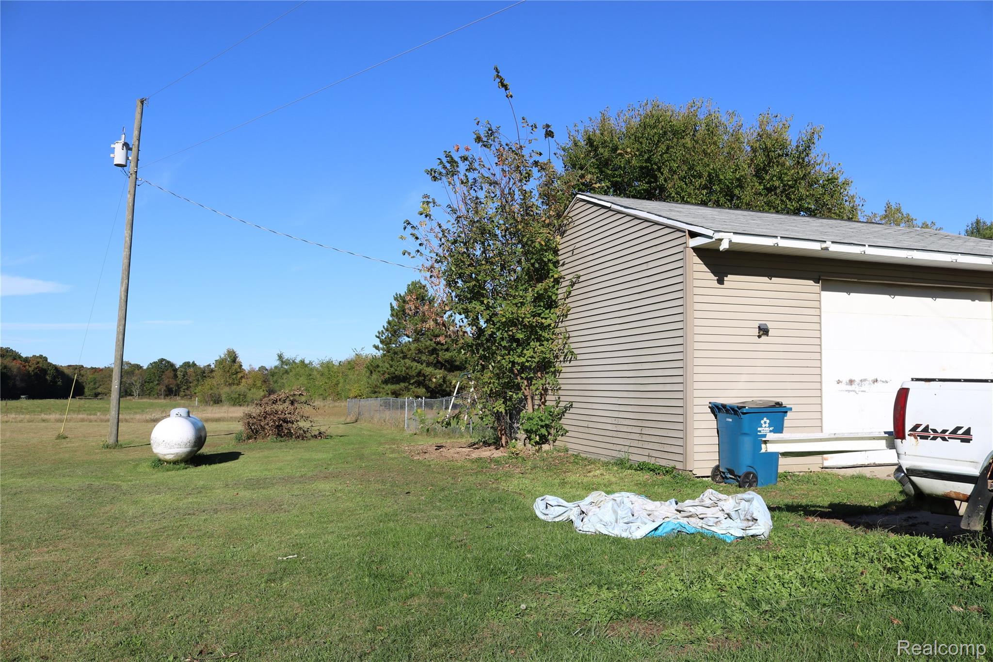 View of yard with a garage and an outdoor structure