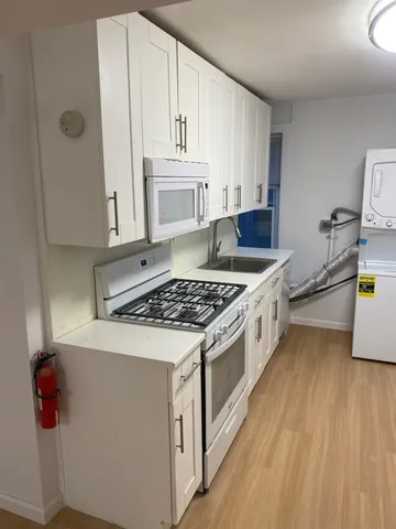 a kitchen with a stove a sink and a refrigerator