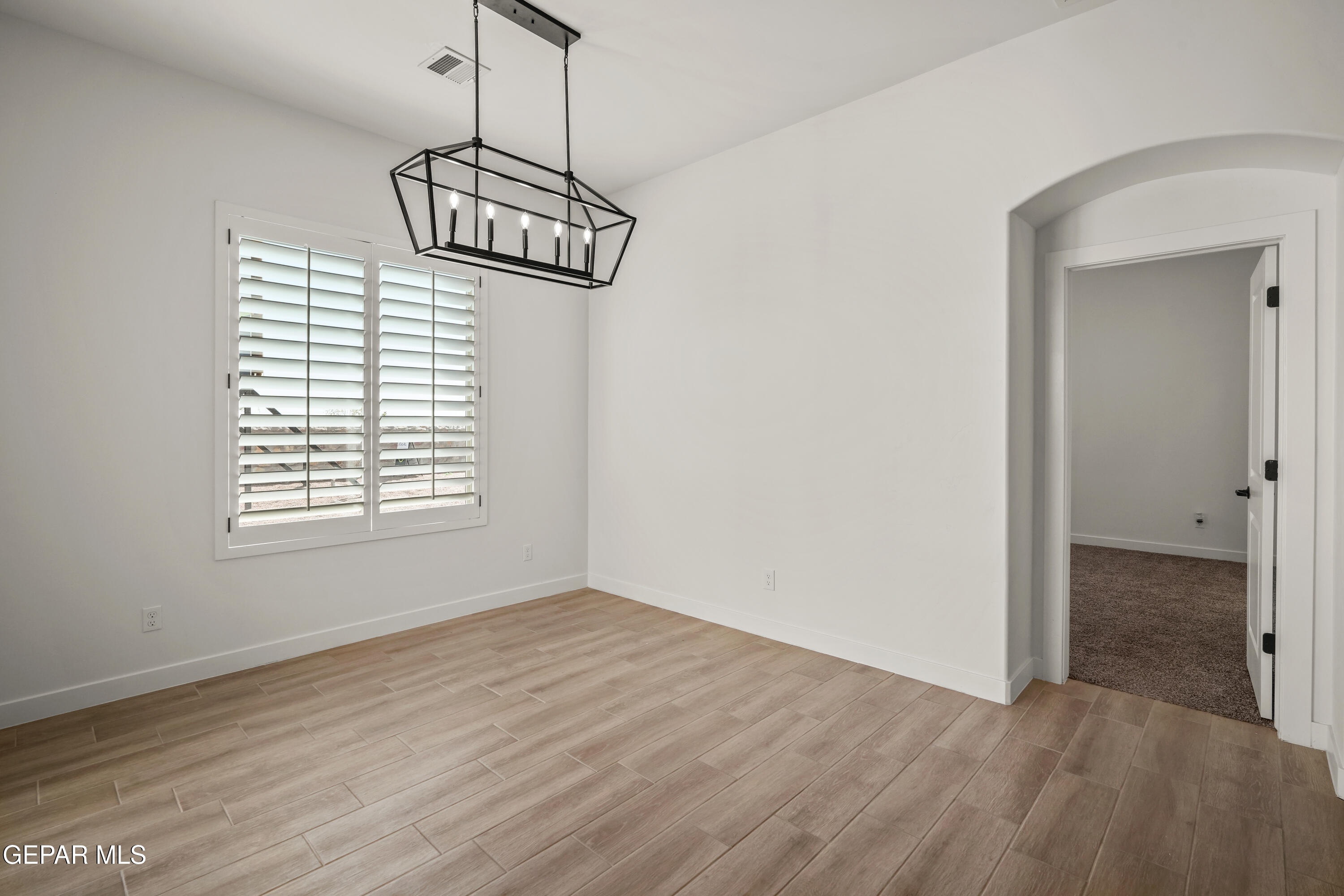15224 Resolve El Paso, TX 79938 - Photo 17 of 38 a view of a room with wooden floor chandelier and windows