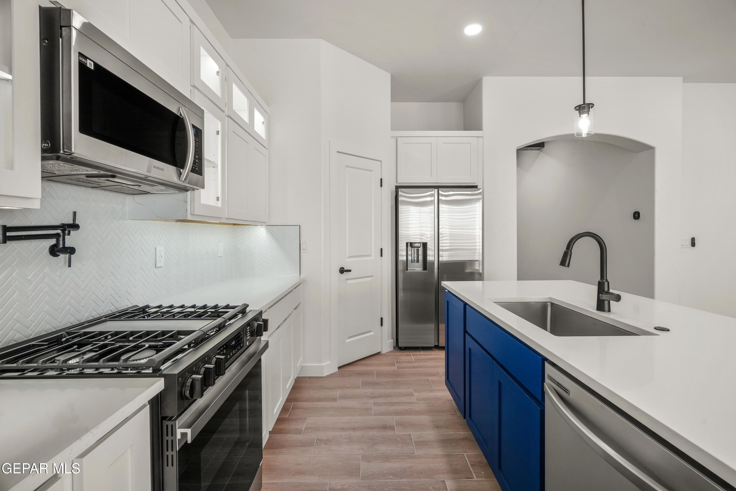 15224 Resolve El Paso, TX 79938 - Photo 21 of 38 a kitchen with kitchen island stainless steel appliances a sink stove and refrigerator