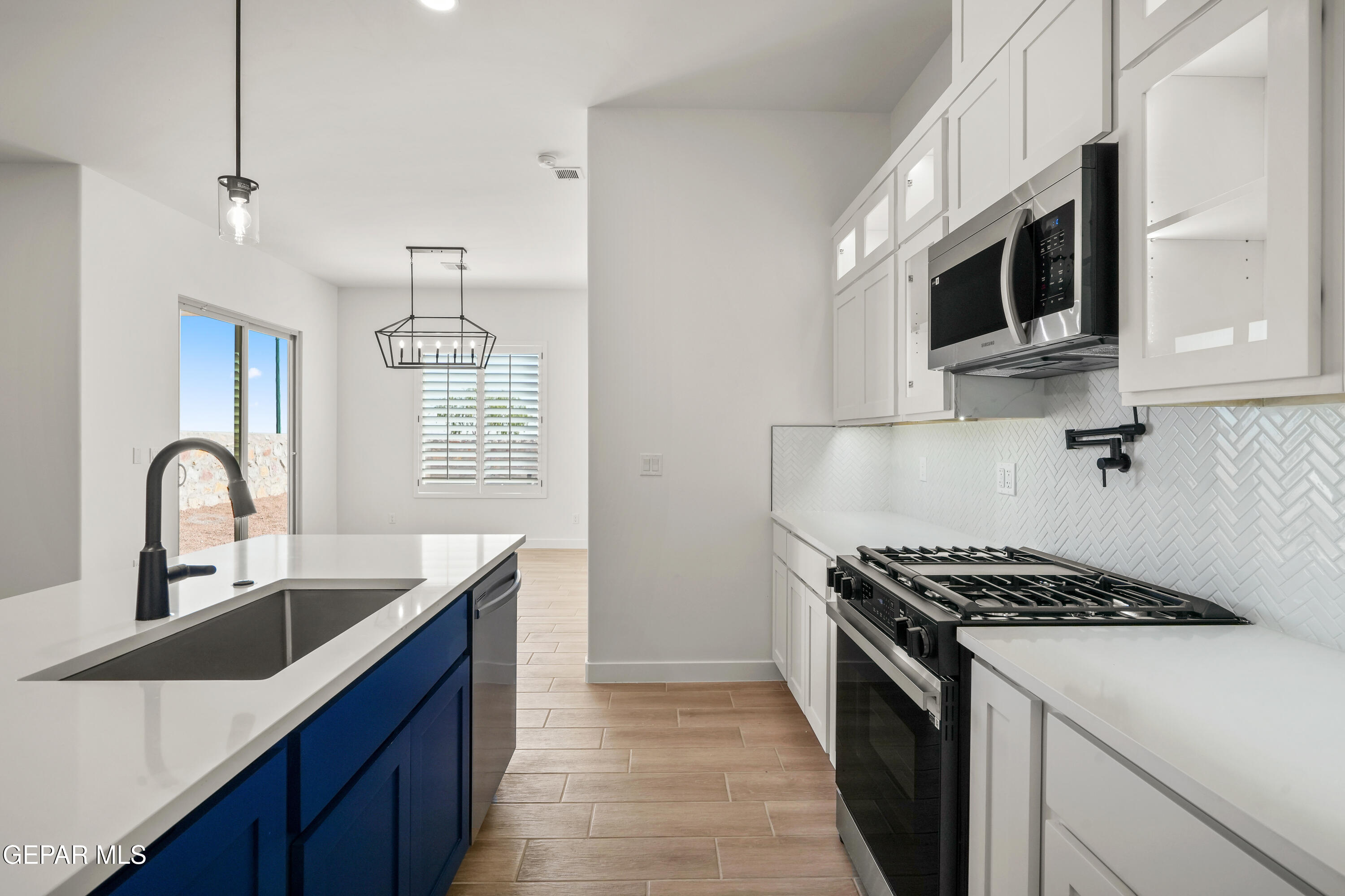 15224 Resolve El Paso, TX 79938 - Photo 23 of 38 a kitchen with stainless steel appliances a sink dishwasher a stove and a microwave oven with cabinets