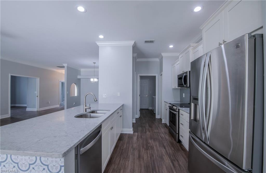 9229 Lanthorn Way Estero, FL 33928 - Photo 11 of 41 a kitchen with stainless steel appliances a refrigerator and a sink